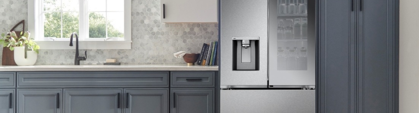 stainless steel fridge next to white countertops